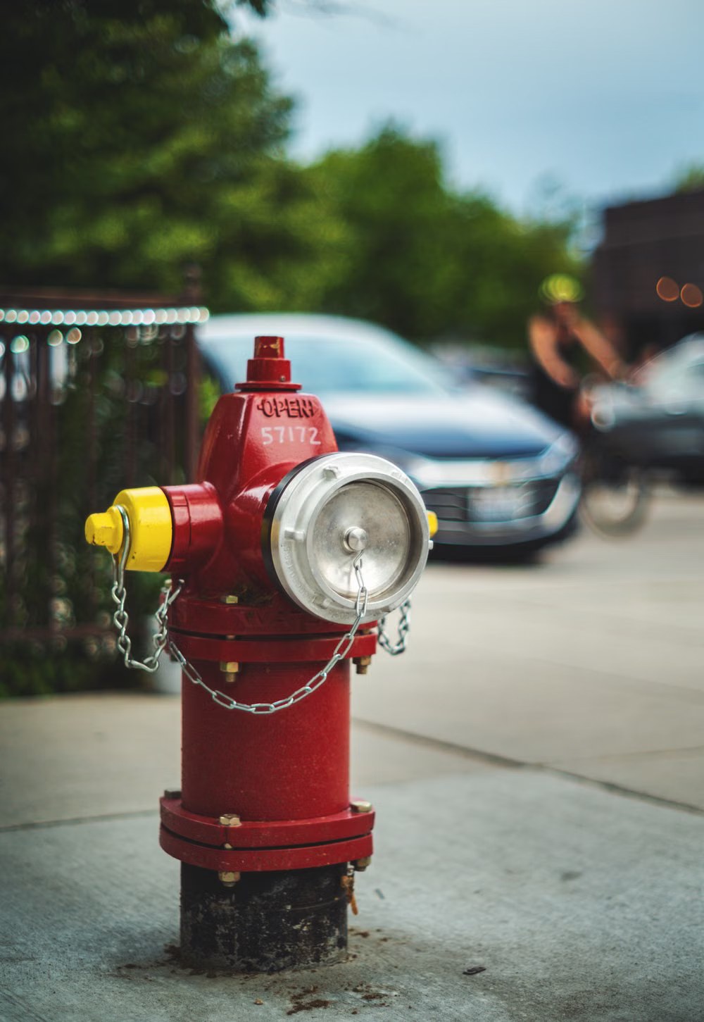 A red fire hydrant on a city sidewalk