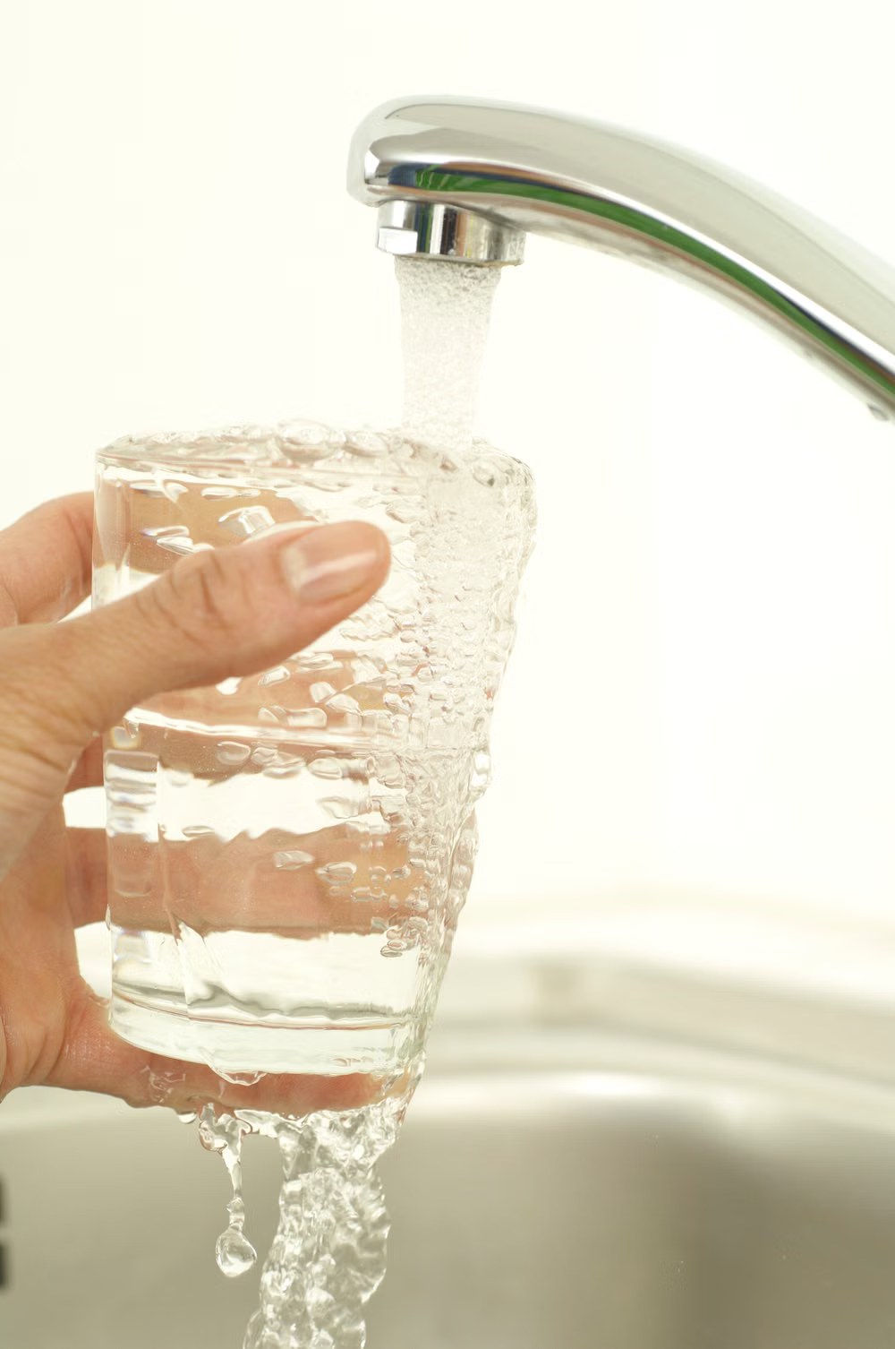 A glass being filled with tap water